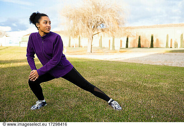 African American woman stretching and warming up before workout