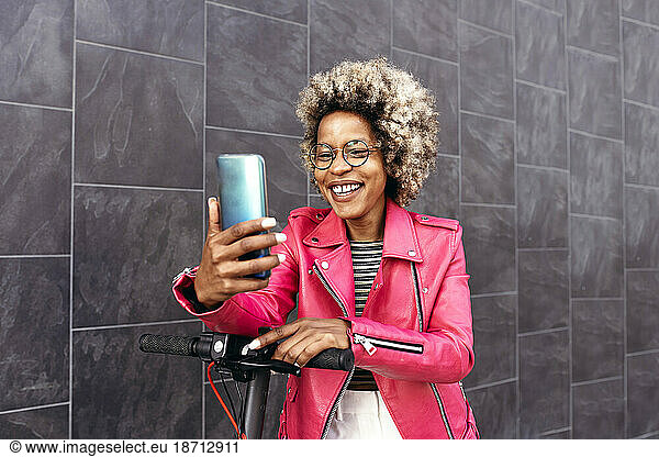 African American woman using the mobile phone in the street