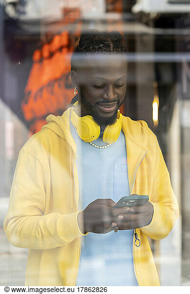 african checking his messages from his smartphone