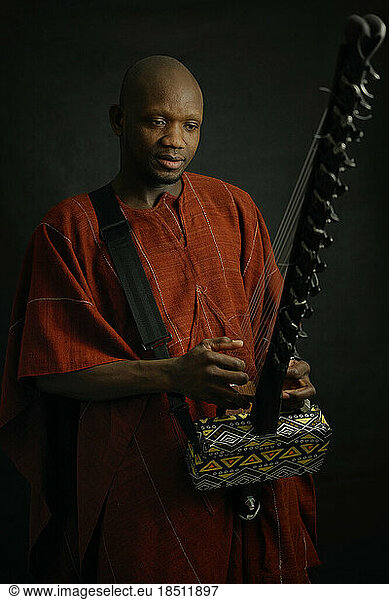 African musician with traditional string instruments.