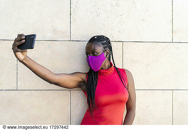 African woman athlete taking a photo from her smartphone