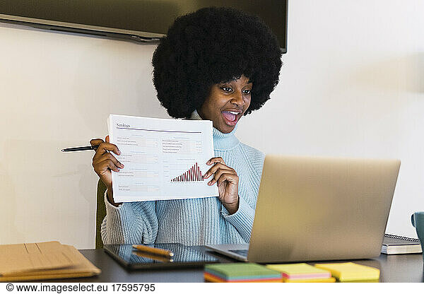 Afro businesswoman giving presentation over laptop at home office