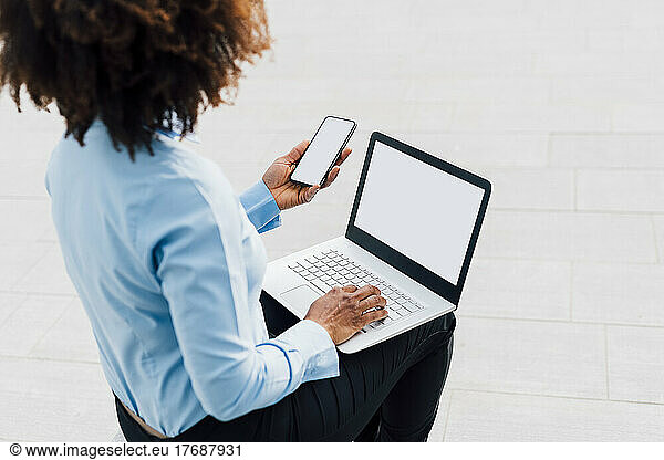 Afro Businesswoman using wireless technologies