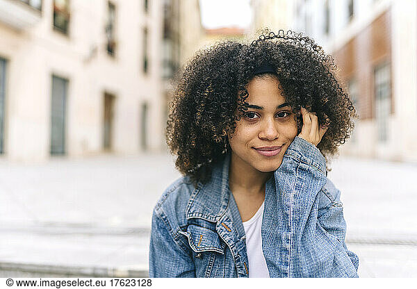 Afro young woman with hand on chin
