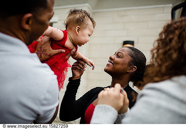 Afroamerikanische Stiefschwester lächelt Biracial-Baby-Schwester an