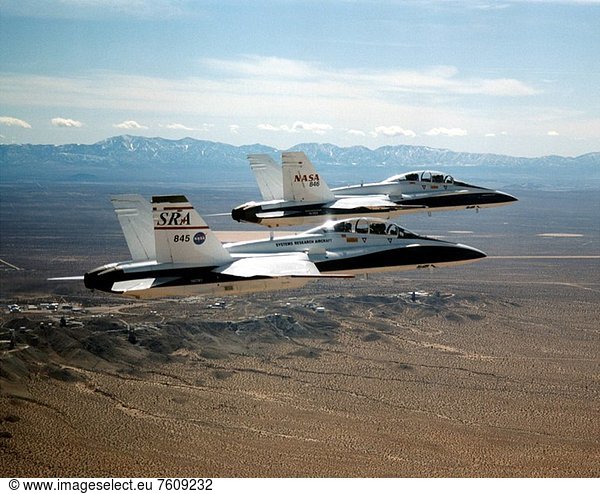 After completing a milestone autonomous station_keeping formation  two F/A_18B aircraft from the NASA Dryden Flight Research Center  Edwards  California  return to base in close formation with the autonomous function disengaged. For the milestone  the aircraft were spaced approximately 200 feet nose_to_tail and 50 feet apart laterally and vertically. Autonomous formation control was maintained by the trailing aircraft  the Systems Research Aircraft SRA  in the lateral and vertical axes to within five feet of the commanded position. Nose_to_tail separation of the aircraft was controlled by manual throttle inputs by the trailing aircraft´s pilot. The milestone was accomplished on the seventh flight of a 12 flight phase. The AFF flights were a first for a project under NASA´s Revolutionary RevCon in Aeronautics Project. Dryden is the lead NASA center for RevCon  an endeavor to accelerate the exploration of high_risk  revolutionary technologies in atmospheric flight. Automated formation flight could lead to formation fuel efficiencies and higher air traffic capacity.