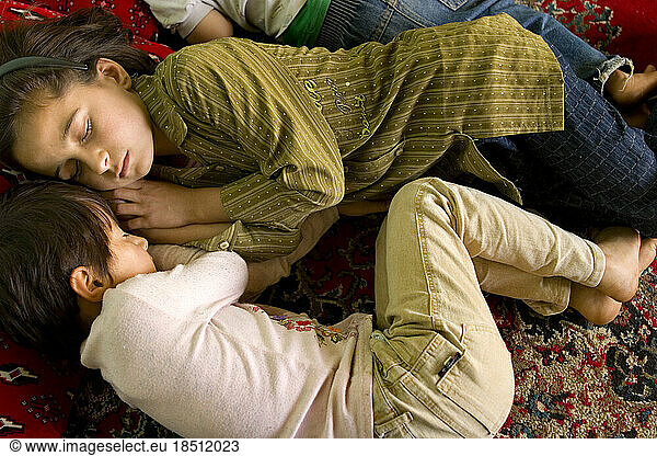 After lunch is nap time at a Kabul preschool. Two girls snuggle up for sleep.