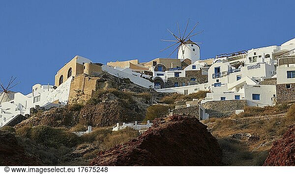 Afternoon light  blue cloudless sky  houses on cliff  windmill  Oia  Santorini Island  Cyclades  Greece  Europe