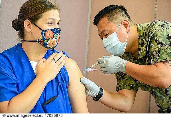 AGANA HEIGHTS  Guam (4. Jan. 2021) ?. ? Hospital Corpsman 2nd Class Mark Forrey  der dem U. S. Naval Hospital Guam (USNH Guam) zugeteilt ist  verabreicht Lt. Cmdr. Allison Wessner  einer dem USNH Guam zugeteilten Kinderärztin  einen Covid-19-Impfstoff. Das DoD hat mit der ersten Lieferung eine begrenzte Menge an COVID-19-Impfstoffdosen erhalten und verabreicht den Impfstoff derzeit dem Personal der Phase 1a  zu dem Gesundheitsdienstleister und Hilfspersonal  Notfalldienste und Mitarbeiter der öffentlichen Sicherheit gehören.