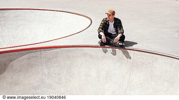 aggressive roller skater chilling in skatepark