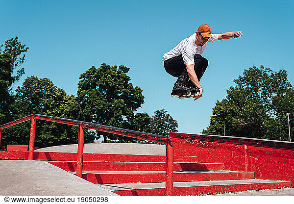 aggressive roller skater performing a trick in skatepark