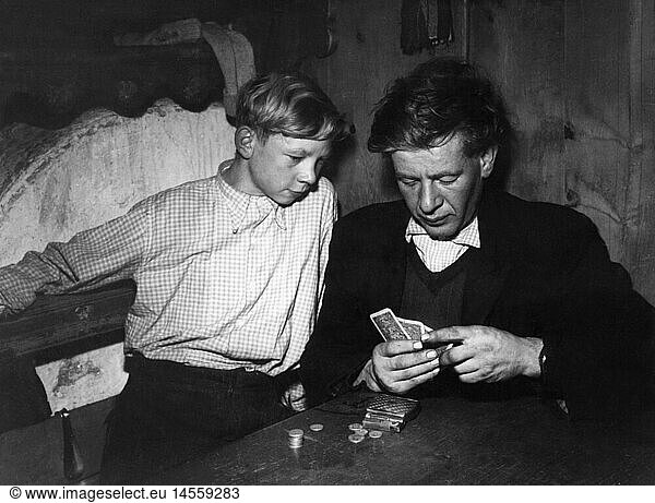 agriculture  mountain farmers  father with son playing cards  1950s