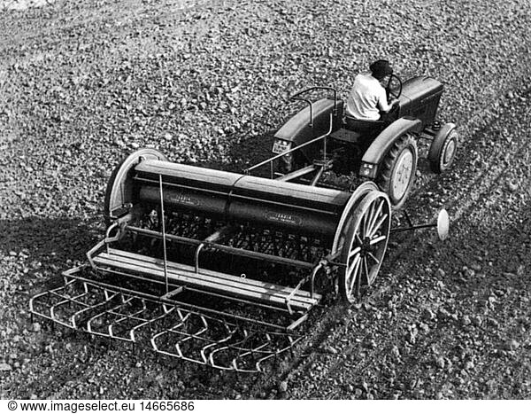agriculture  tools  seeder drawn by a tractor  20th century  20th century  agricultural work  farm labour  farm labor  tillage  tilth  arable farming  field  fields  sowing  sow  sough  seeding  seed  tractor  tractors  agriculture  farming  tool  tools  seeder  sowing machine  seeders  sowing machines  air-seeder  drawing  draw  historic  historical  male  man  people  men