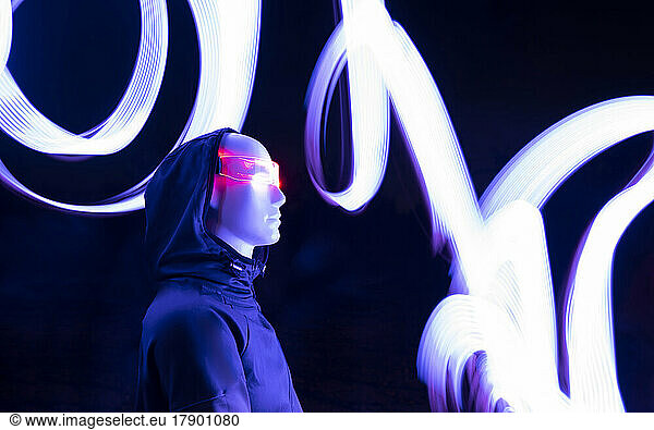 AI cyborg wearing futuristic eyeglasses standing by light trail