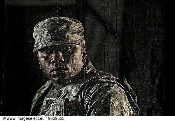 Air Force Security Forces member secures the stairwell of a building during clearing operations training.