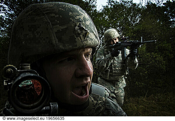 Air Force Security Forces members bound toward the enemy during tactical maneuvers training.