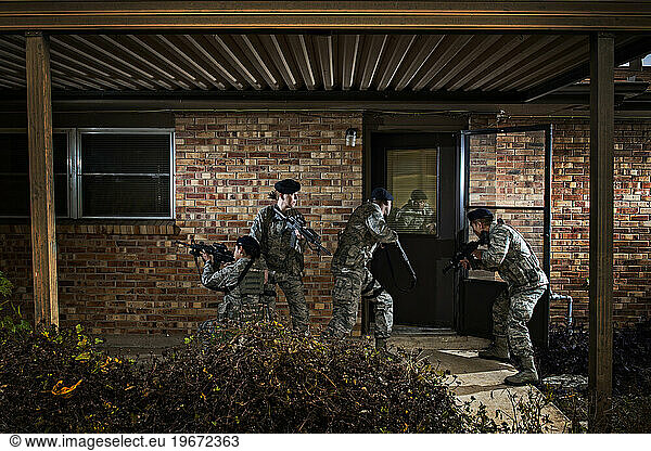 Air Force Security Forces members prepare to tactically enter the house during clearing operations training.