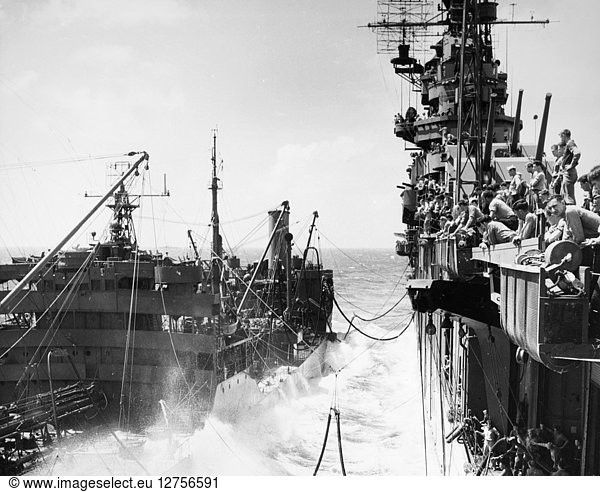 AIRCRAFT CARRIER: REFUELING. The crew of the aircraft carrier USS Lexington watches as a tanker refuels their ship during World War II. Photograph  c1943.