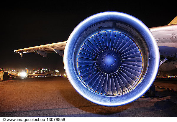 Aircraft jet engine on runway at night