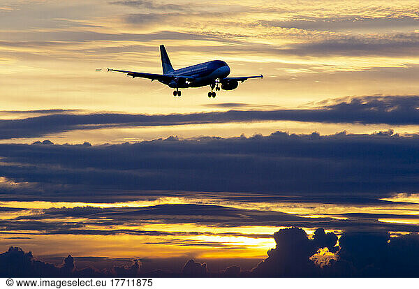 Airplane Approaching At Sunset.