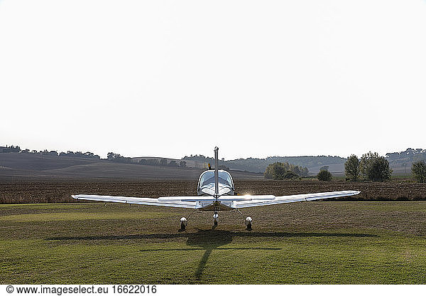 Airplane at airfield during sunny day