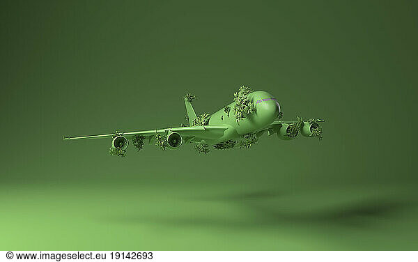 Airplane covered with green plants against green background
