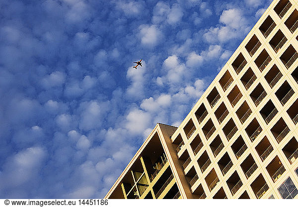 Airplane Flying Over Building