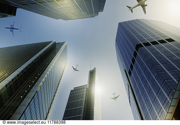 Airplanes flying over highrise buildings  travel concept