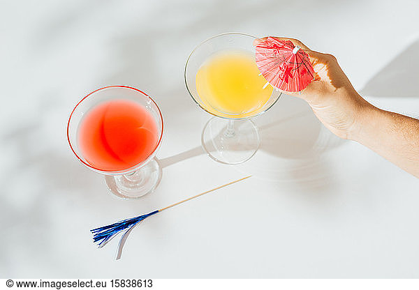 Alcoholic cocktails with marked shadows of the midday sun