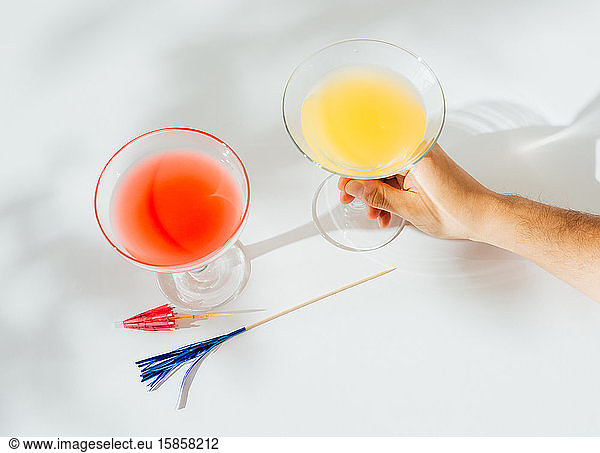 Alcoholic cocktails with marked shadows of the midday sun