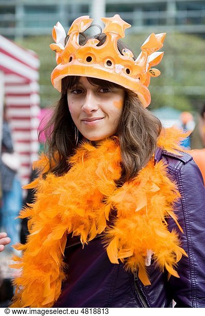 All kinds of people dress in orange close during Queensday in the Netherlands