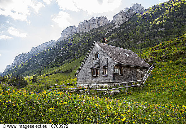 Alpine hut below limestone spires in Alpstein  Appenzell  Switzerland