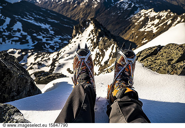 alpine mountaineering boots with crampons on top of a mountain summit
