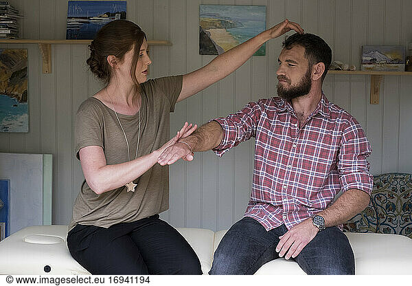 Alternative therapist and man during a consultation  using EFT tapping techniques therapy