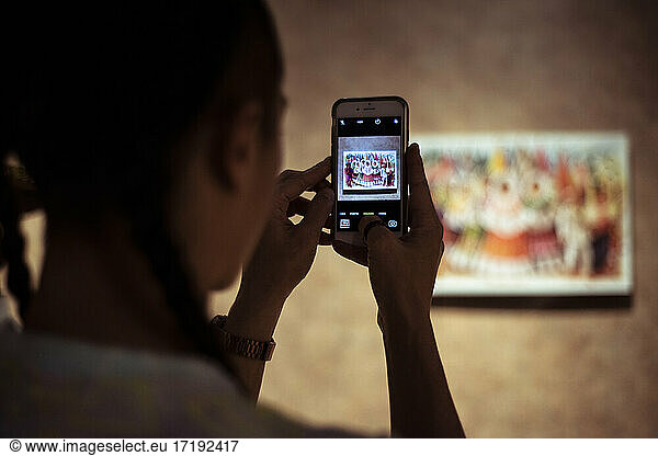Alternative tourist take phone photo of painting at Fridas House