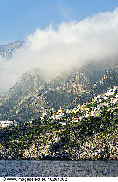 Amalfi coast town under a low cloud