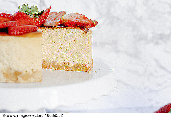 Amarula cream cheese cake with strawberries  a piece cut