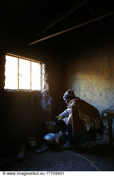 Amaryan Woman Cooking In Village Hut; Cordillera Real  Bolivia