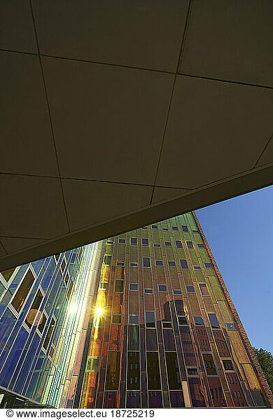 Amazing colourful reflective facade of a modern office building in sun