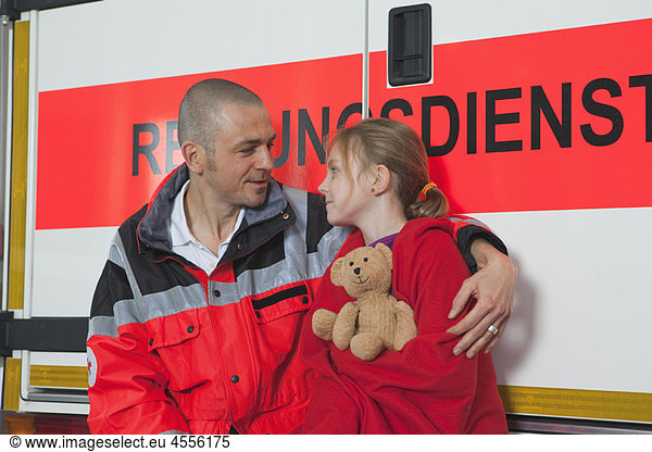 Ambulance man caring about girl at coach