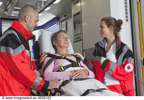 Ambulance team caring about woman