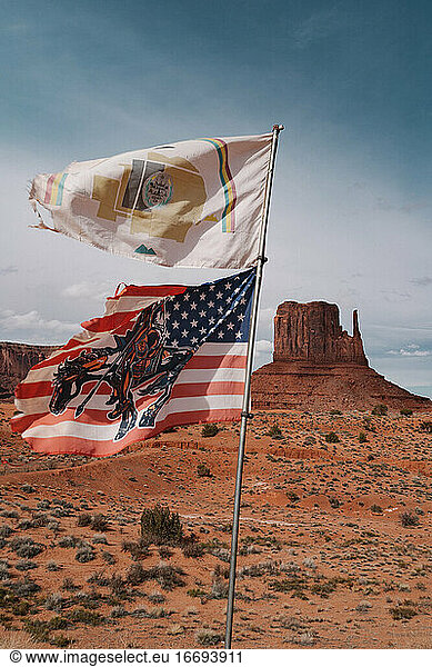 American and Navajo's flags moving with the wind in Monument Valley