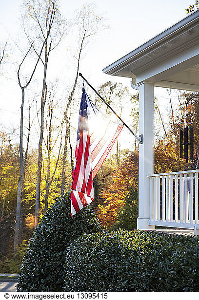 American flag hanging in front of house