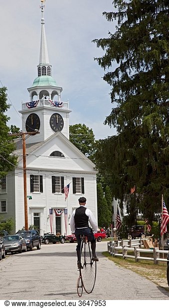 Amherst  New Hampshire - A man rides an antique high wheel bicycle near the Congregational Church of Amherst following the town´s July 4 parade