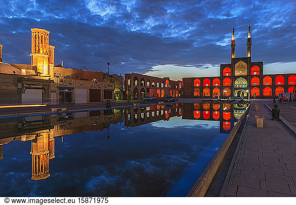Amir Chaqmaq complex facade illuminated at sunrise and reflecting in a pond  Yazd  Yazd province  Iran  Middle East