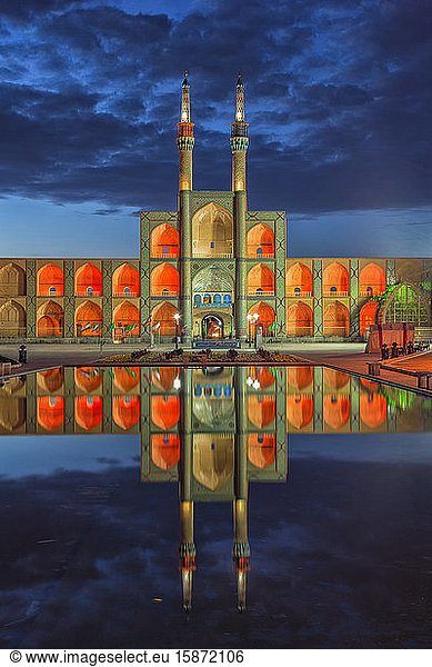 Amir Chaqmaq complex facade illuminated at sunrise and reflecting in a pond  Yazd  Yazd province  Iran  Middle East