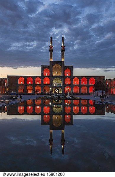 Amir Chaqmaq complex facade illuminated at sunrise and reflecting in a pond  Yzad  Yazd province  Iran  Asia