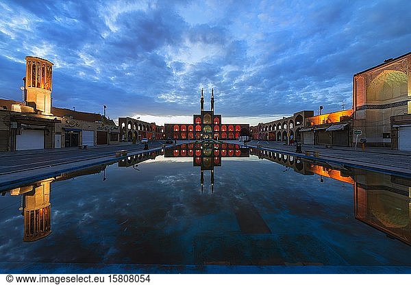 Amir Chaqmaq complex facade illuminated at sunrise and reflecting in a pond  Yzad  Yazd province  Iran  Asia