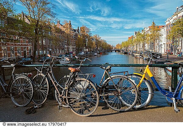 Amterdam cityscape with canal  bridge with bicycles and medieval houses. Amsterdam  Netherlands
