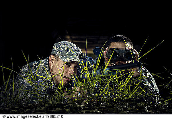 An advanced Air Force Security Forces sniper team observe potential targets during training.